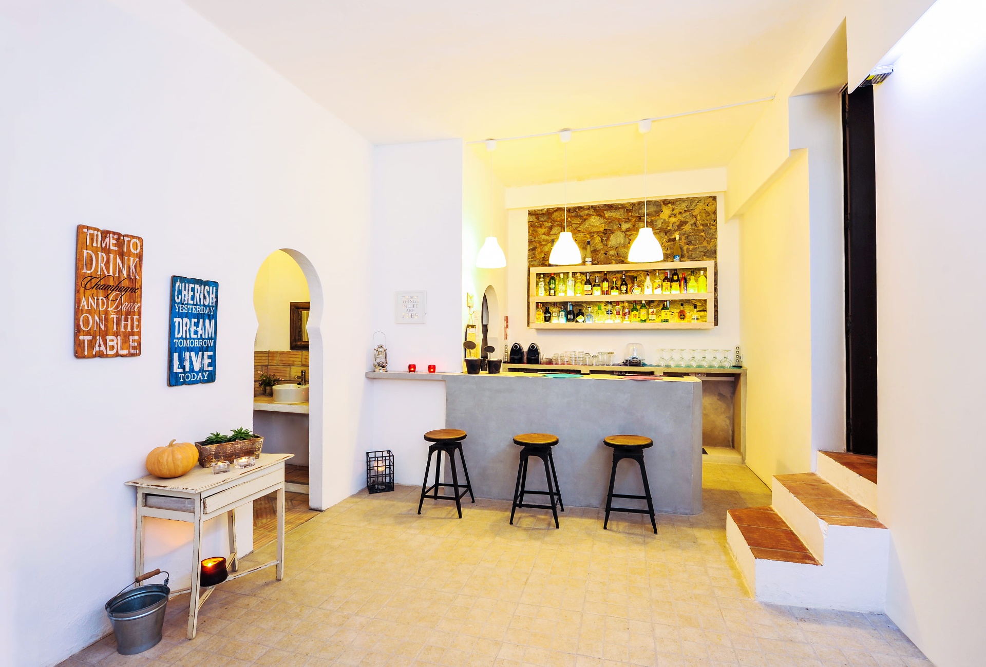 Bar do restaurante com arco mouro e prateleira de garrafas