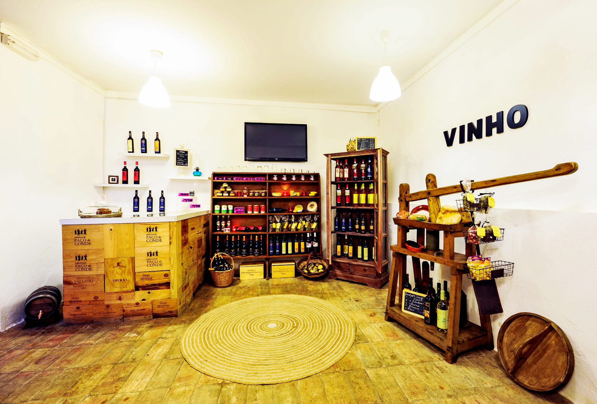 Loja de vinhos e produtos regionais da Casa Amarela com garrafas em prateleiras de madeira